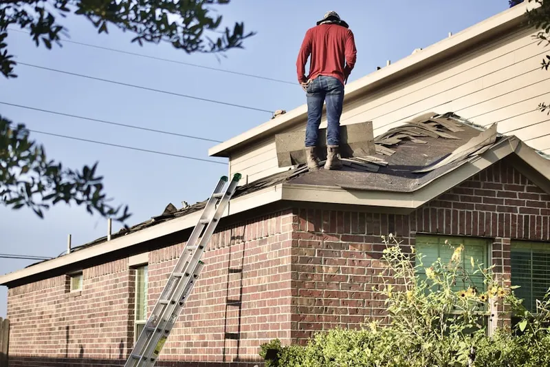Professional roofer working on a residential roof in Rising Corner